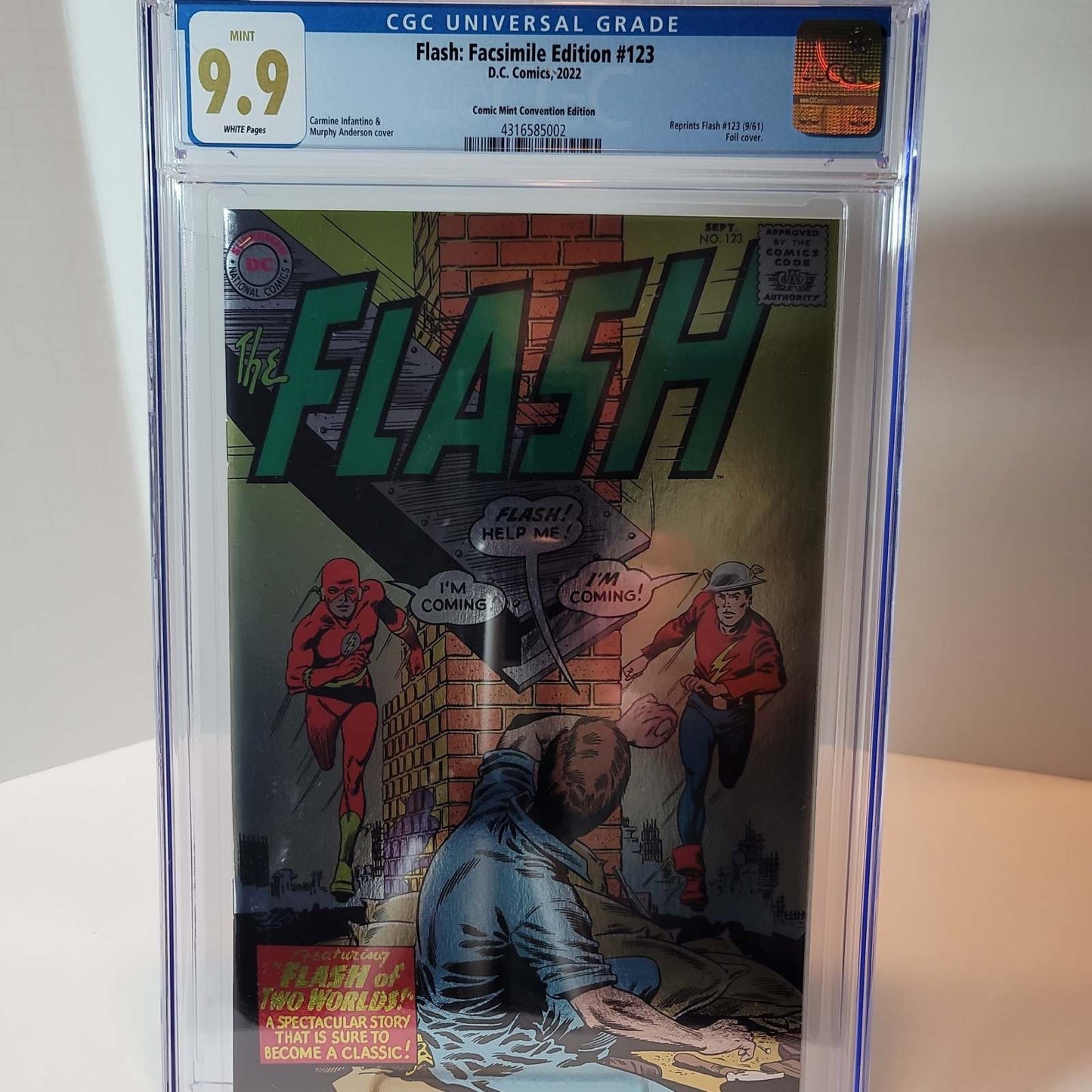 A sealed, transparent plastic packaging containing a collectible comic book, labeled as 'Flash #123 Foil Facsimile Edition CGC 9.9' with a blue label featuring character artwork.