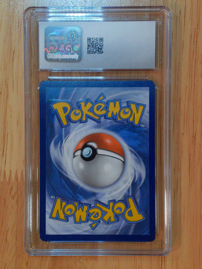 Pokémon trading card in a clear protective case on a wooden surface
